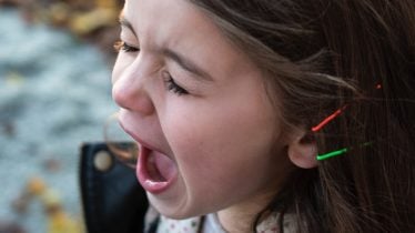 girl-wearing-black-jacket-and-gray-shirt-with-open-mouth-116151